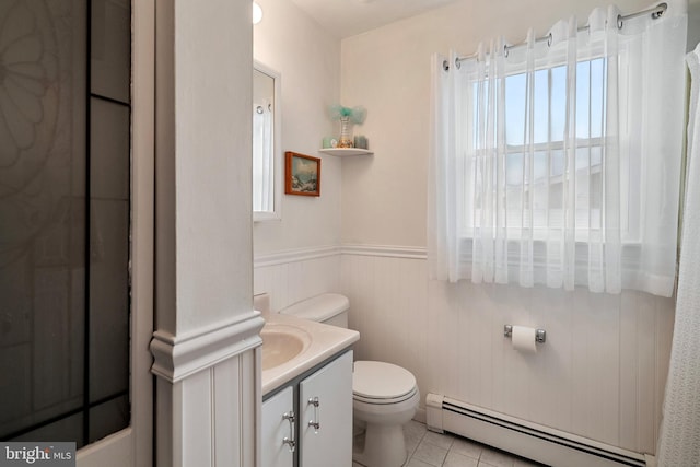 bathroom featuring a baseboard radiator, vanity, tile patterned floors, and toilet