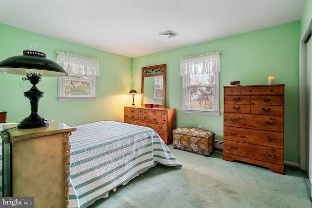 carpeted bedroom with a baseboard radiator