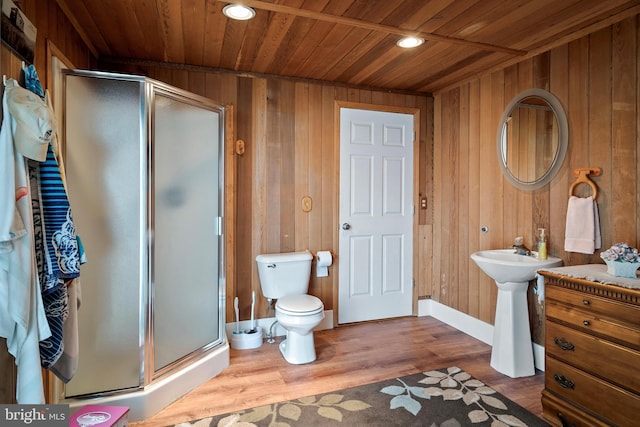 bathroom featuring wood ceiling, wooden walls, a shower with door, and hardwood / wood-style flooring