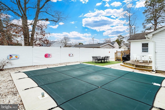 view of swimming pool featuring a deck