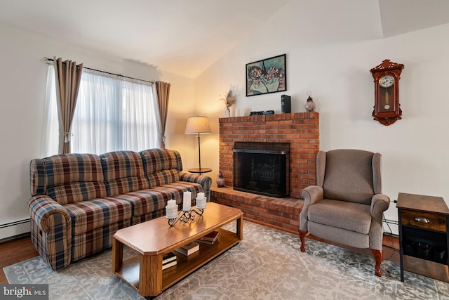 living room with a baseboard radiator, a fireplace, vaulted ceiling, and hardwood / wood-style floors