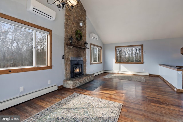 unfurnished living room featuring plenty of natural light, a baseboard heating unit, and a wall mounted air conditioner