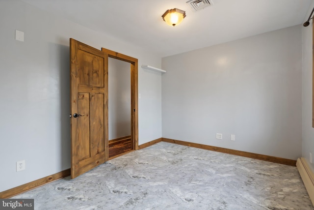 unfurnished bedroom with baseboard heating