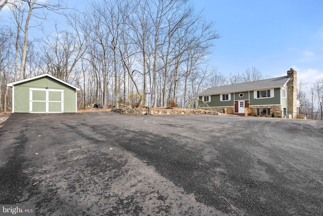 view of front of house featuring a garage and an outdoor structure