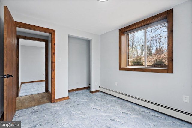 unfurnished bedroom featuring a baseboard heating unit