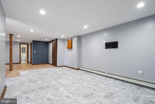 basement with a baseboard radiator and a barn door