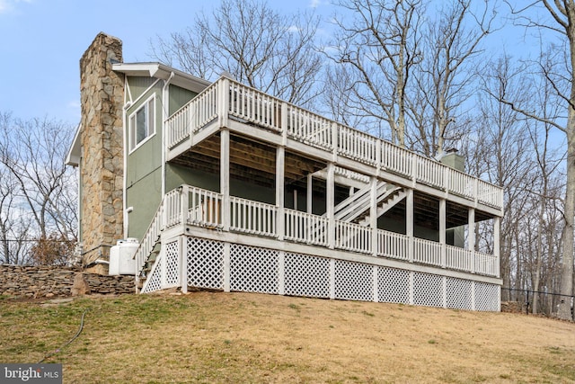 rear view of house featuring a yard and a deck