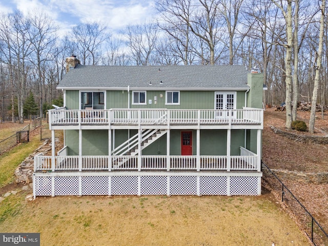 view of front facade with a front lawn and a deck