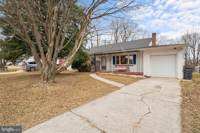 ranch-style house featuring a front lawn, a garage, and a porch