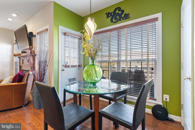 dining space with wood-type flooring