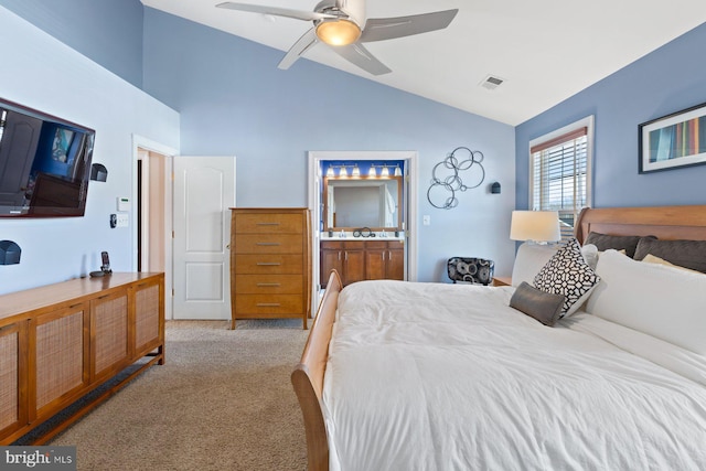 bedroom with light carpet, vaulted ceiling, ceiling fan, and ensuite bathroom