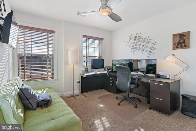 carpeted office space with ceiling fan