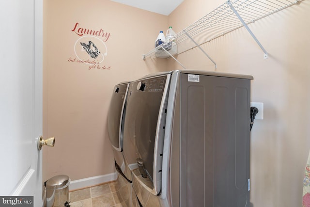 laundry area featuring light tile patterned flooring and washer and clothes dryer