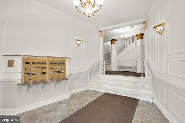 interior space featuring crown molding, a notable chandelier, and a decorative wall