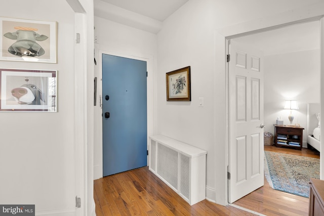 hallway featuring visible vents and wood finished floors