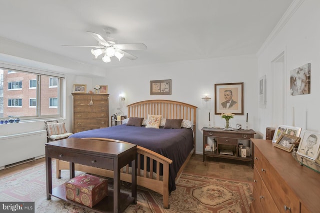 bedroom with crown molding and ceiling fan