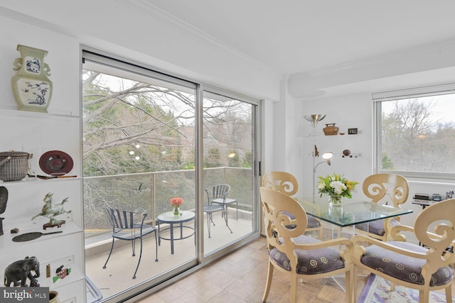 dining space with ornamental molding