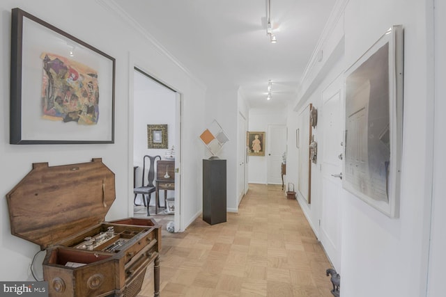 hall featuring crown molding and baseboards