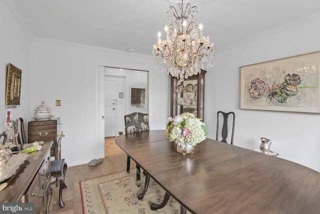 dining area with an inviting chandelier and crown molding