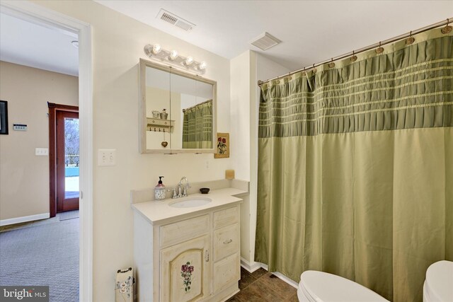 full bathroom featuring visible vents, toilet, and vanity