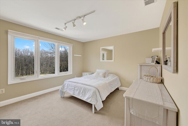 bedroom with visible vents, carpet floors, and baseboards