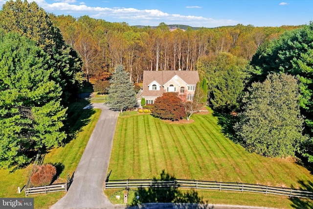 birds eye view of property with a view of trees