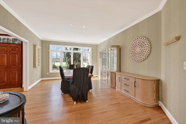 dining space with light wood-style flooring, baseboards, and a healthy amount of sunlight