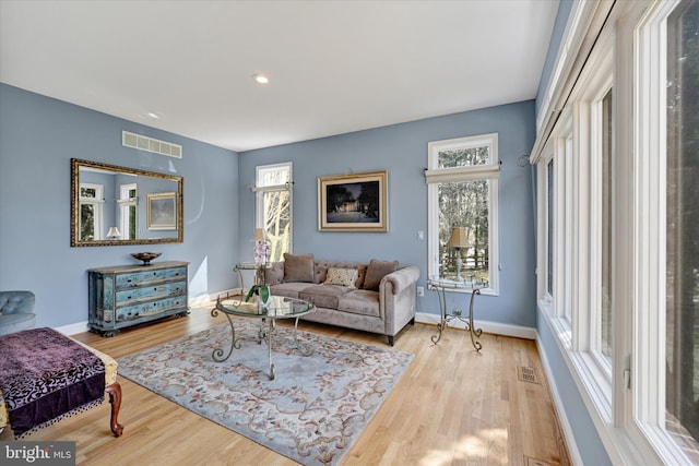 living area featuring recessed lighting, visible vents, baseboards, and wood finished floors