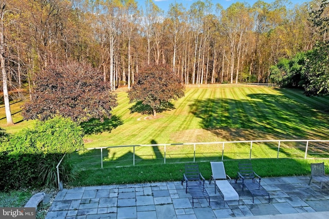 exterior space featuring fence, a lawn, and a patio area