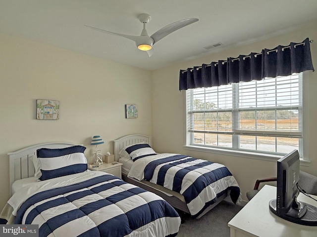 bedroom with multiple windows, carpet floors, and ceiling fan