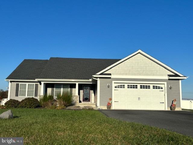 single story home with a garage and a front lawn