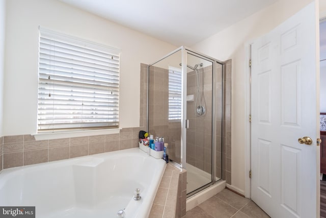 bathroom featuring tile patterned flooring and plus walk in shower