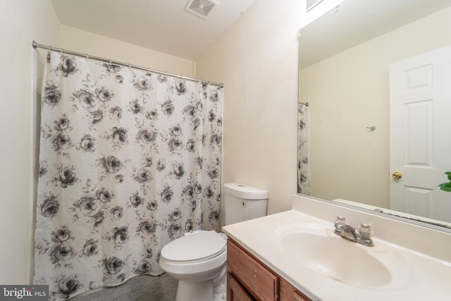 bathroom featuring vanity, a shower with shower curtain, and toilet