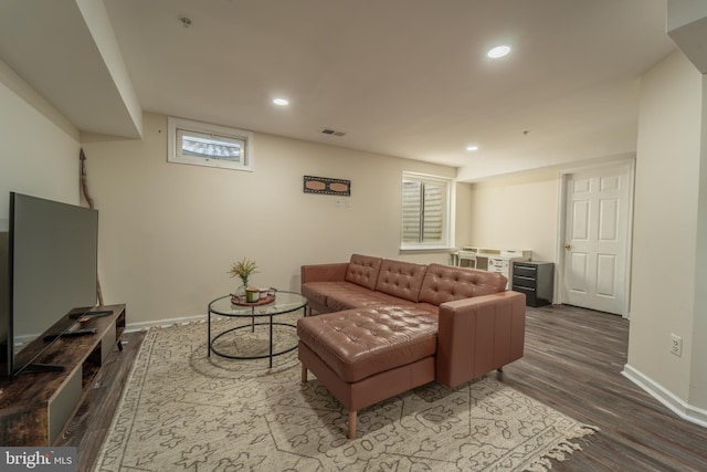 living room featuring plenty of natural light and dark hardwood / wood-style floors