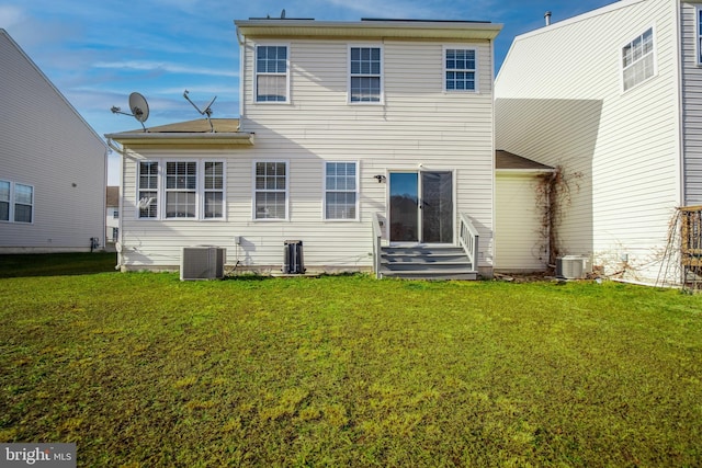 rear view of property featuring a yard and central AC unit