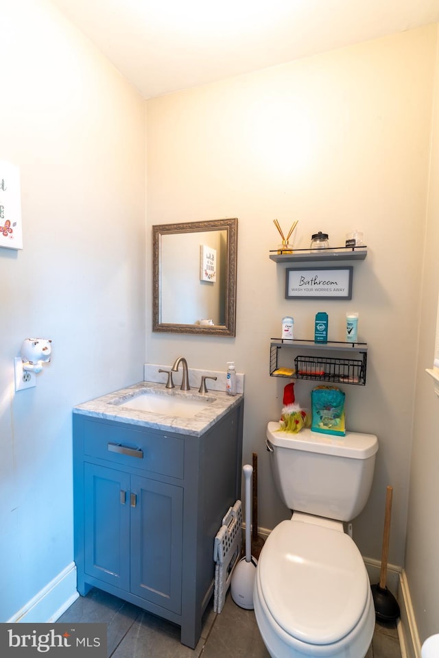 bathroom featuring vanity, toilet, and tile patterned flooring