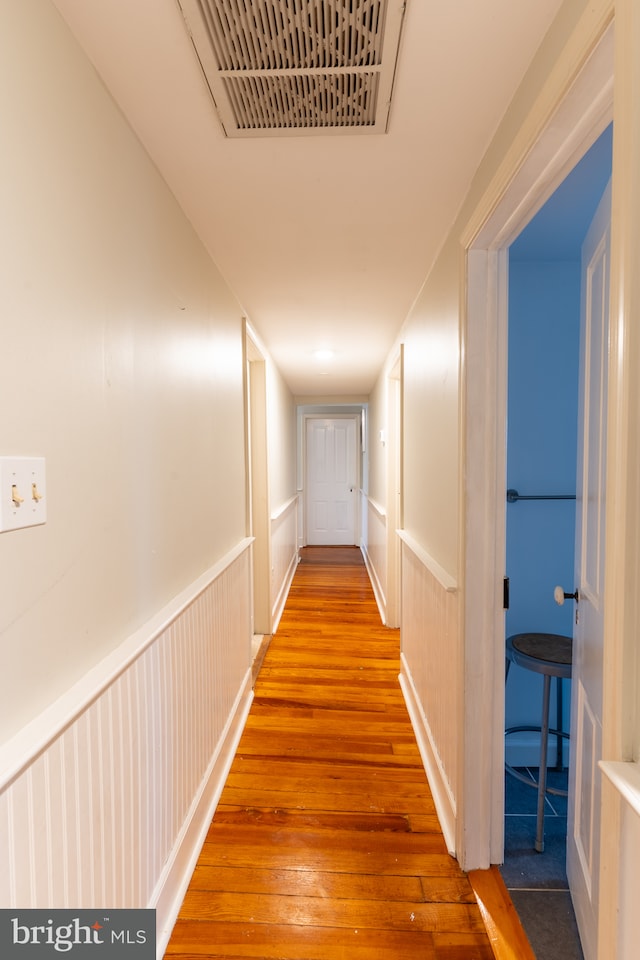 hallway with wood-type flooring