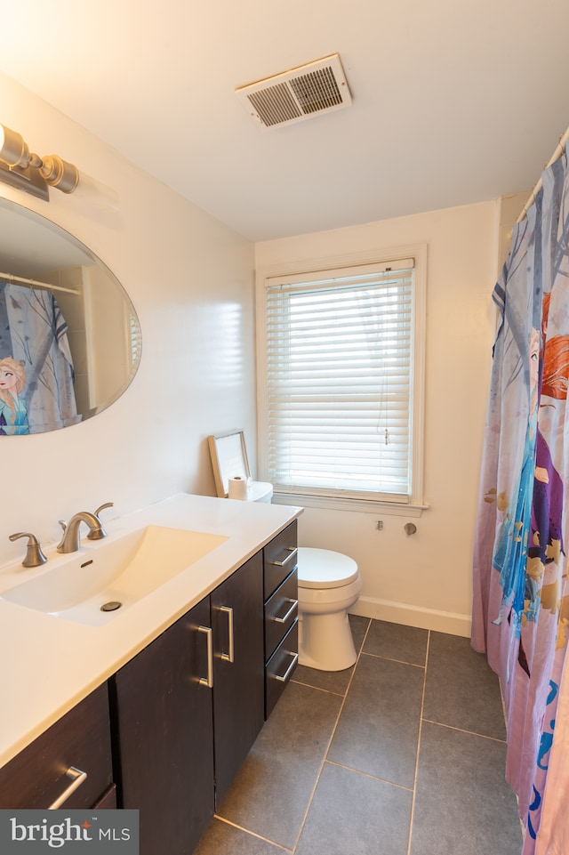 bathroom with vanity, tile patterned floors, and toilet