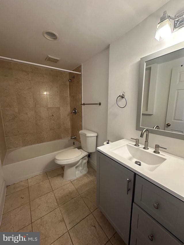 full bathroom with vanity, toilet, and tiled shower / bath