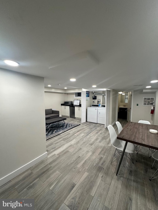 dining room with wood-type flooring and separate washer and dryer