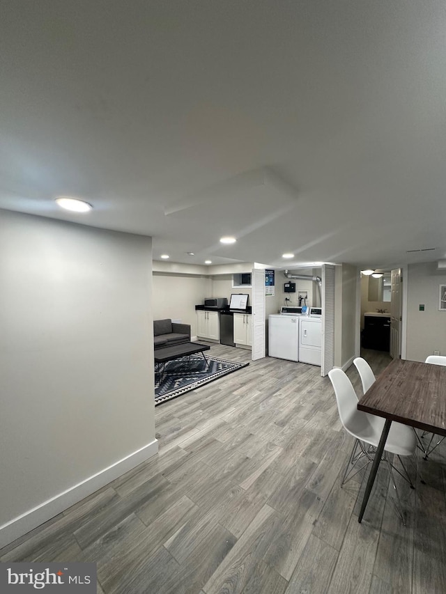 interior space with hardwood / wood-style flooring and washing machine and clothes dryer