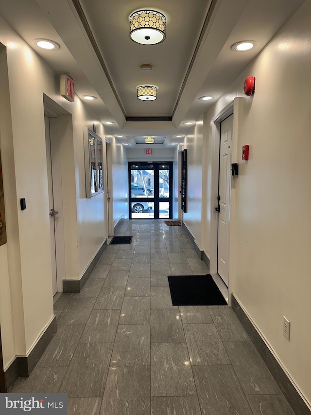 hallway with a tray ceiling