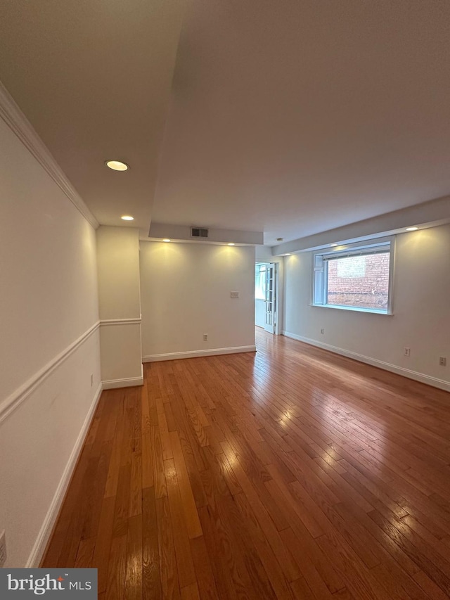 spare room featuring ornamental molding and wood-type flooring