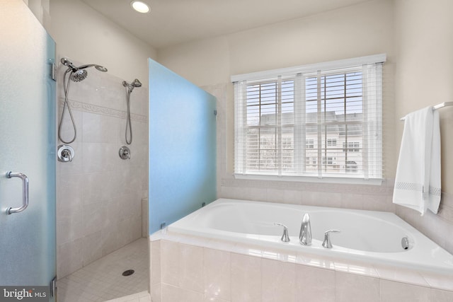 bathroom featuring shower with separate bathtub