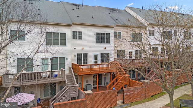 back of house featuring a wooden deck and central air condition unit