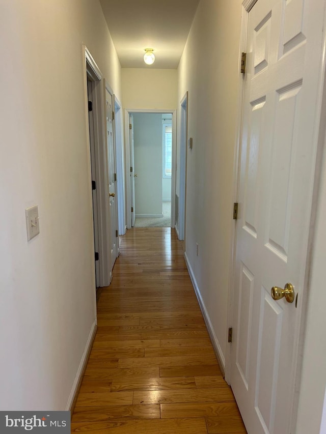 hall with light hardwood / wood-style floors