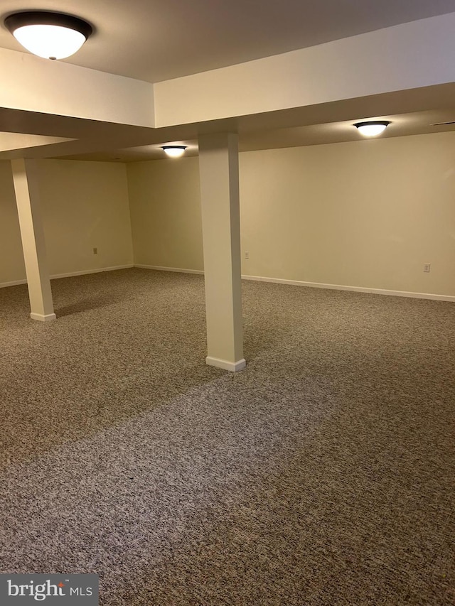 basement featuring dark carpet