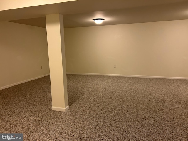 basement featuring dark colored carpet