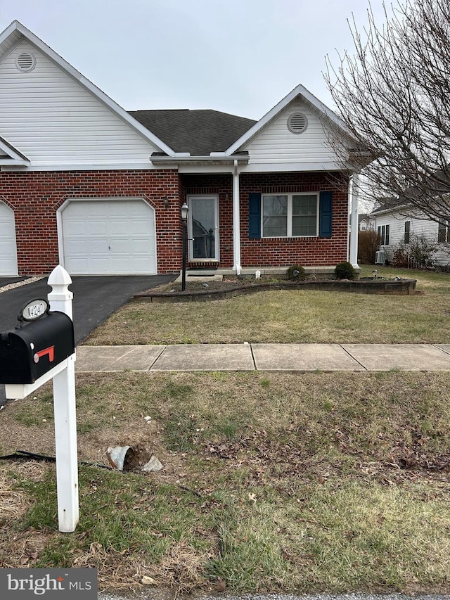 single story home featuring a garage and a front yard