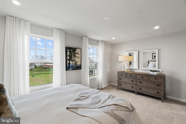 bedroom featuring light carpet, baseboards, and recessed lighting